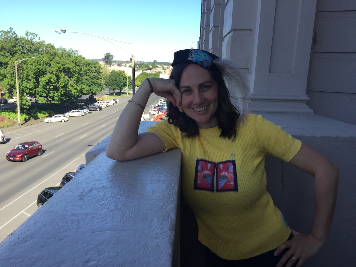 Amy on balcony with Gather hat